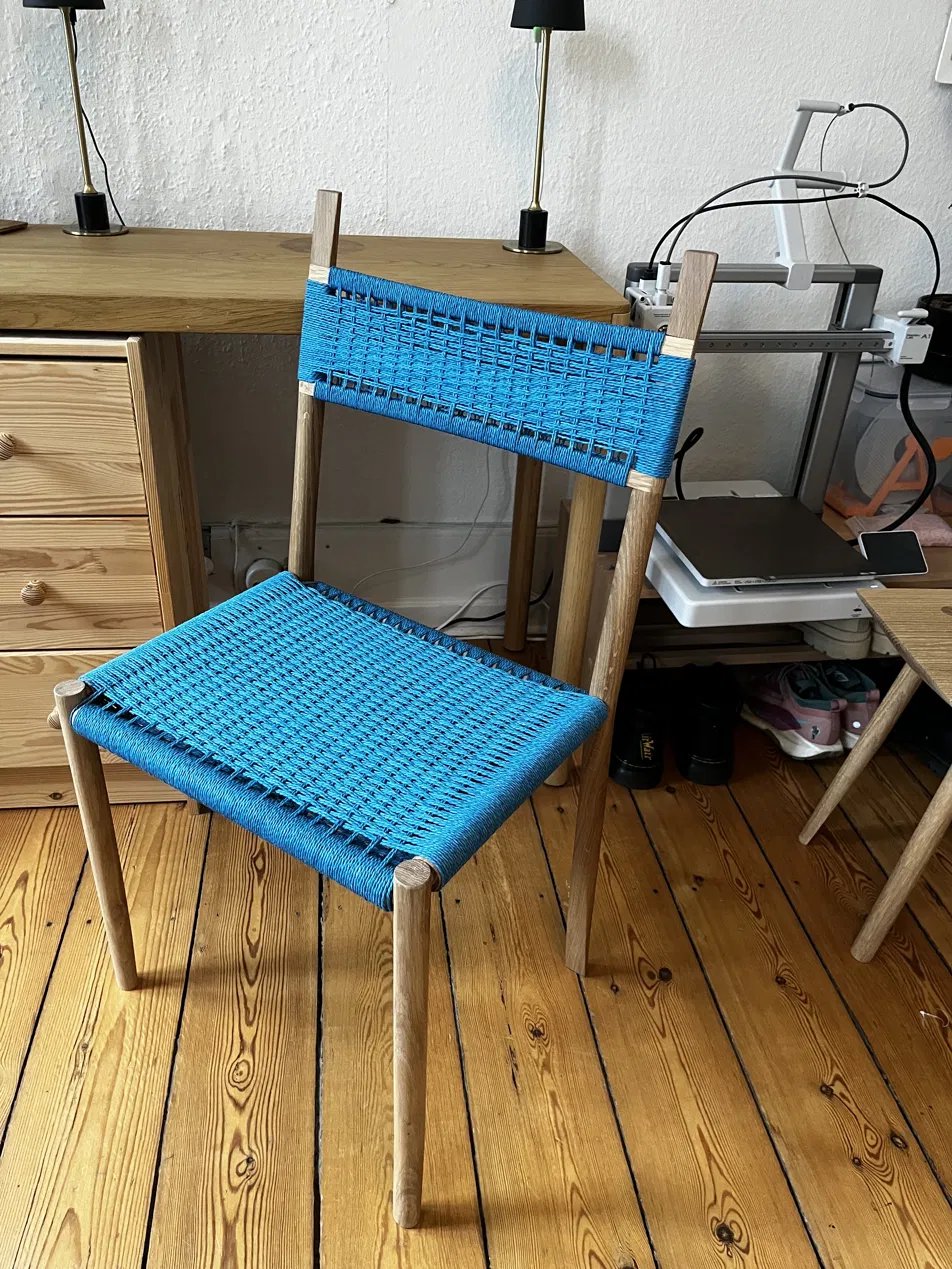 The dining chair prototype with a woven cord seat and back